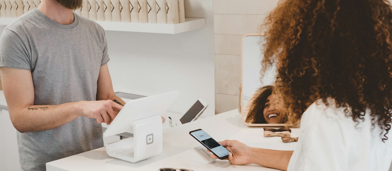 Customer at a counter checking a phone